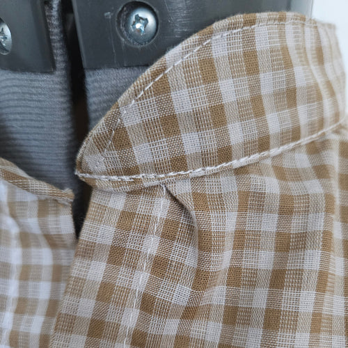 Close up of collar tuck in beige gingham fabric