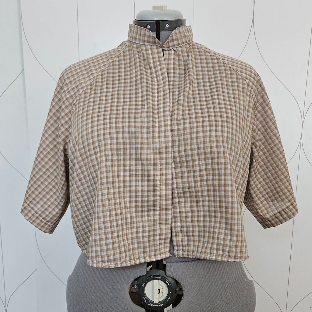Front view of beige gingham button-up shirt