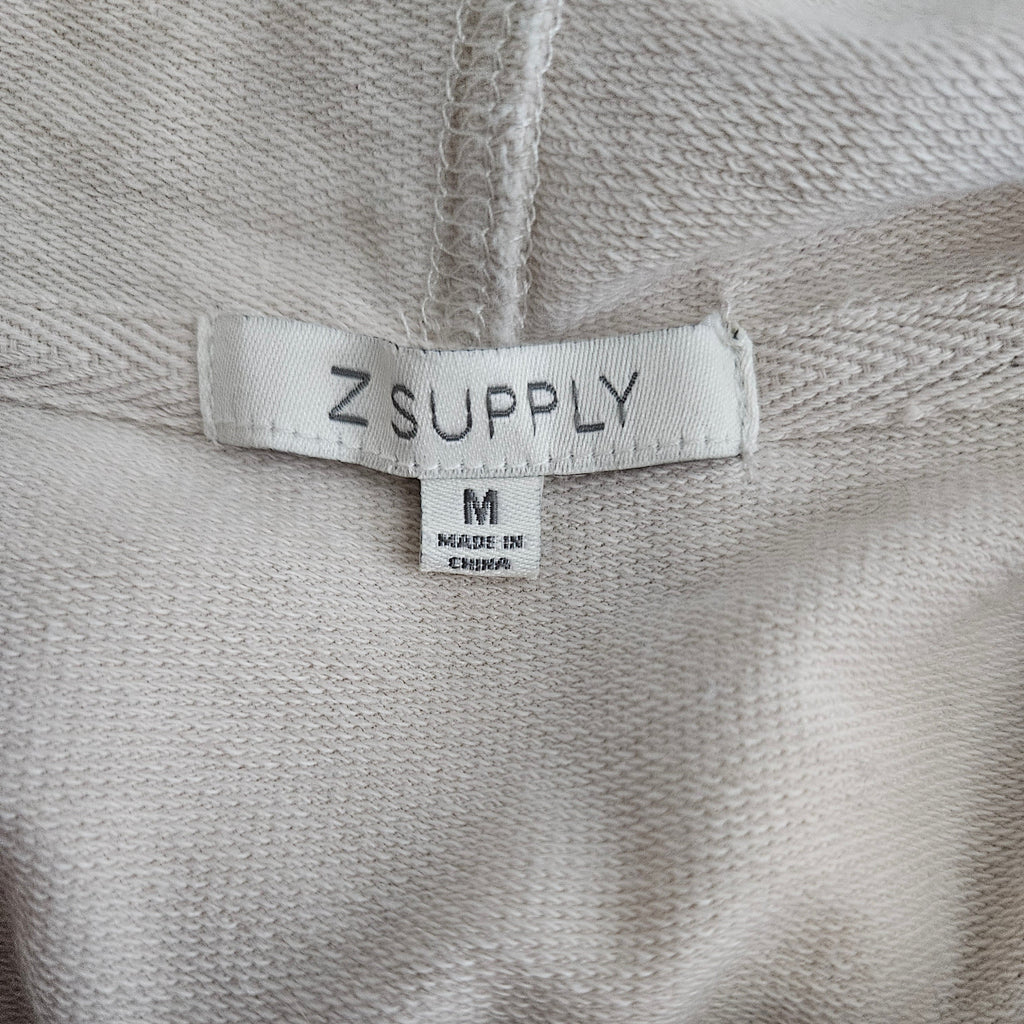 Brand tag on beige fabric background