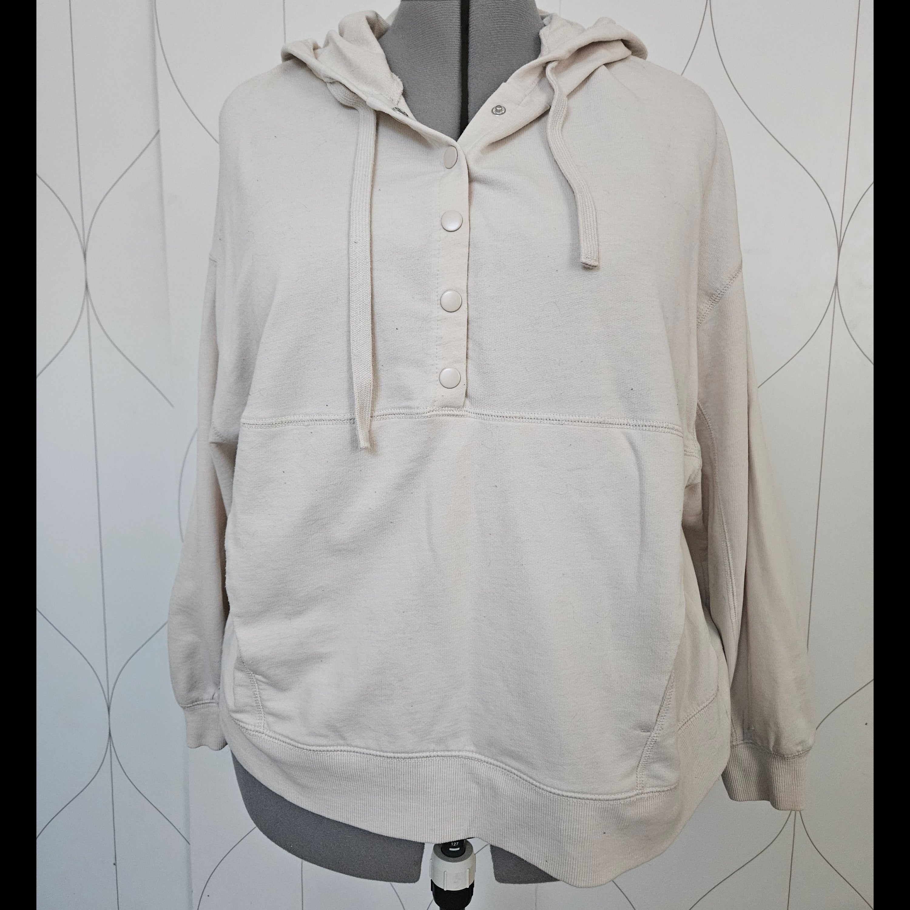 Front view of beige hoodie with snaps