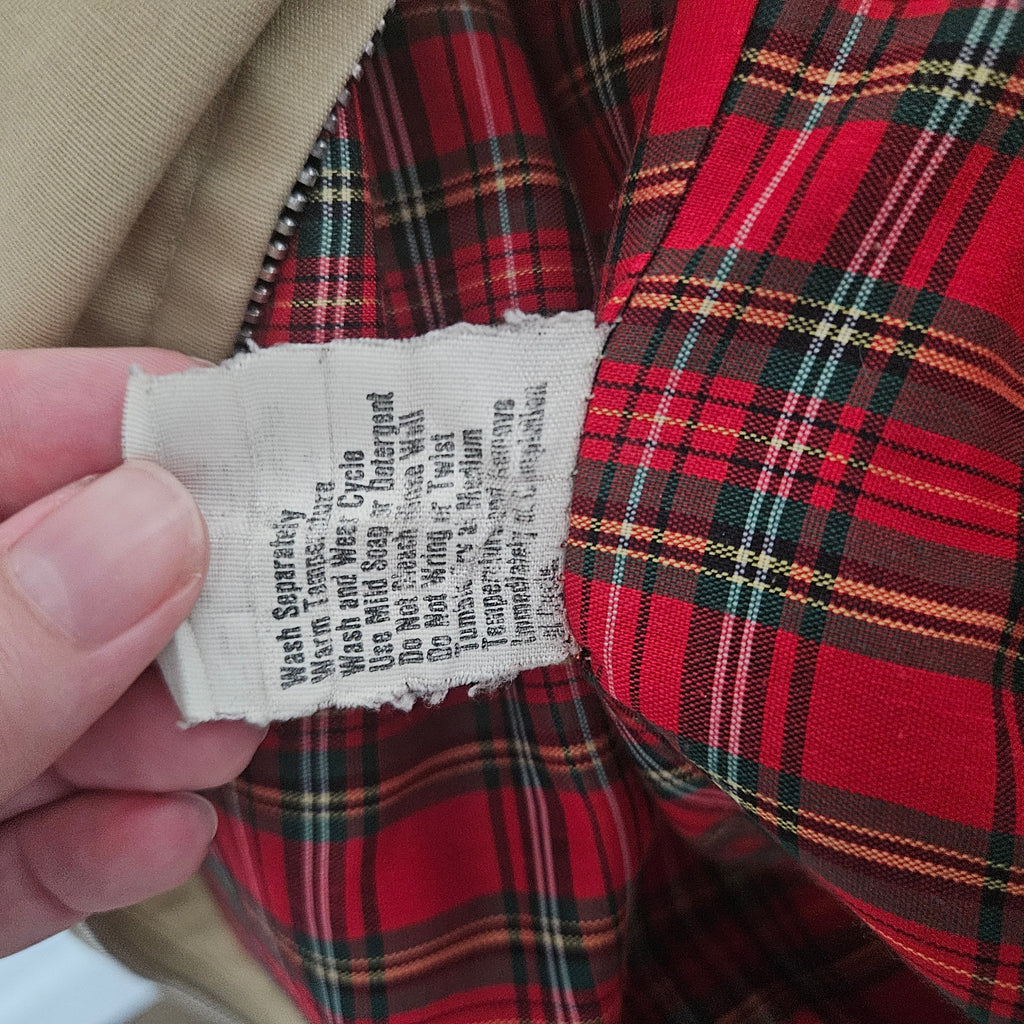 Care instructions tag on a red plaid background