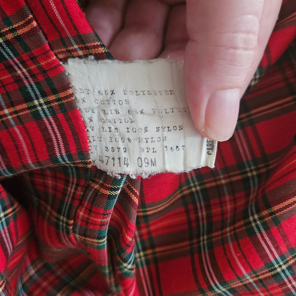 Clothing tag on a red plaid background