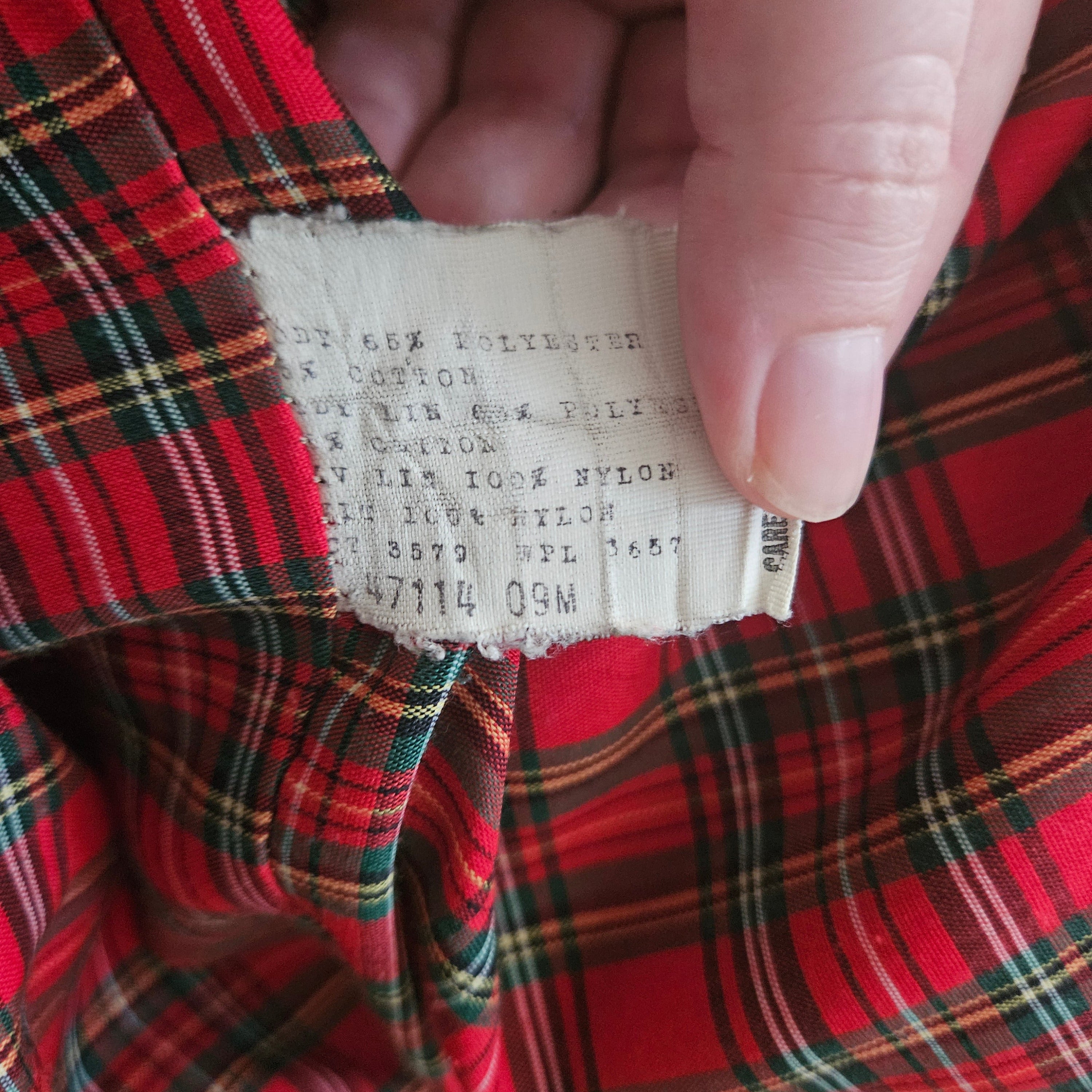 Clothing tag on a red plaid background