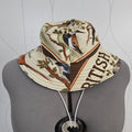 A patterned bucket hat with a bird and leaf design, featuring the word 'BRITISH' printed on the side, displayed on a gray mannequin torso.