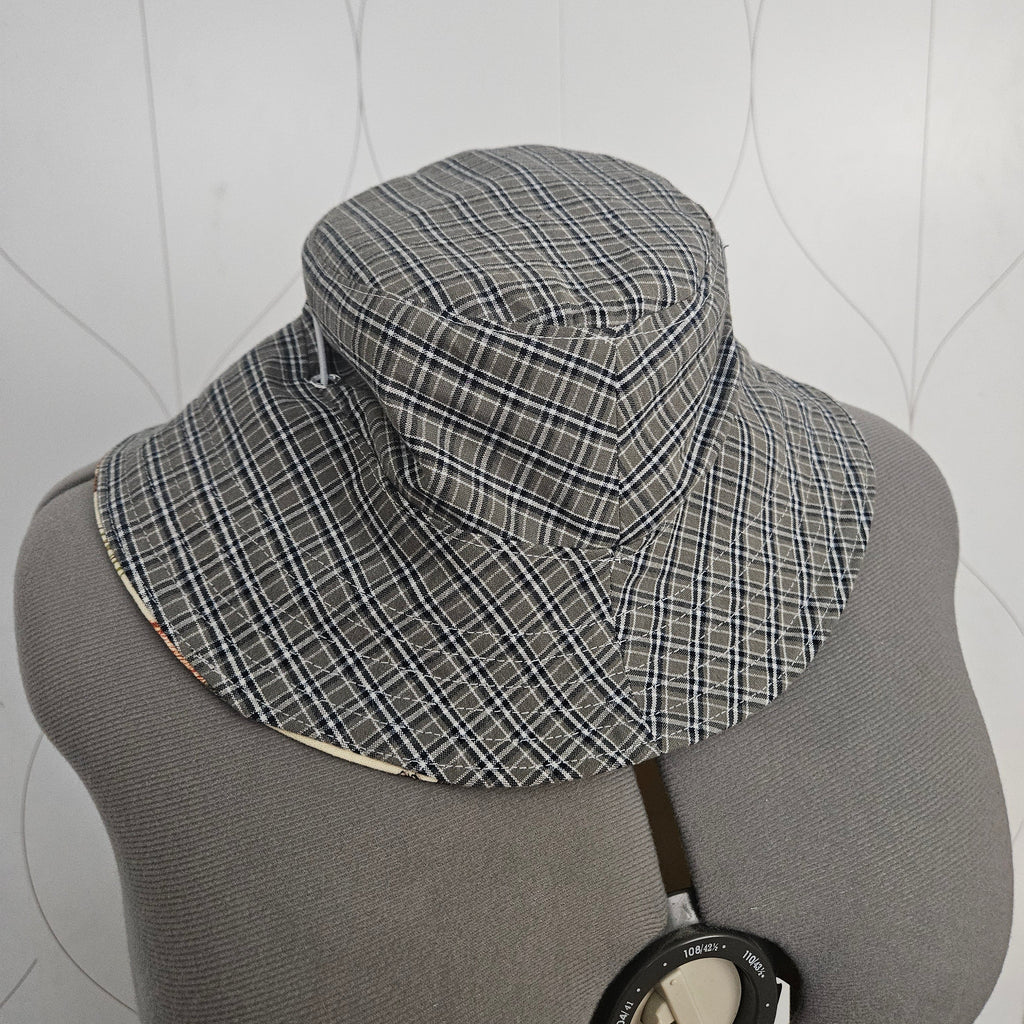 Green plaid bucket hat on a gray mannequin