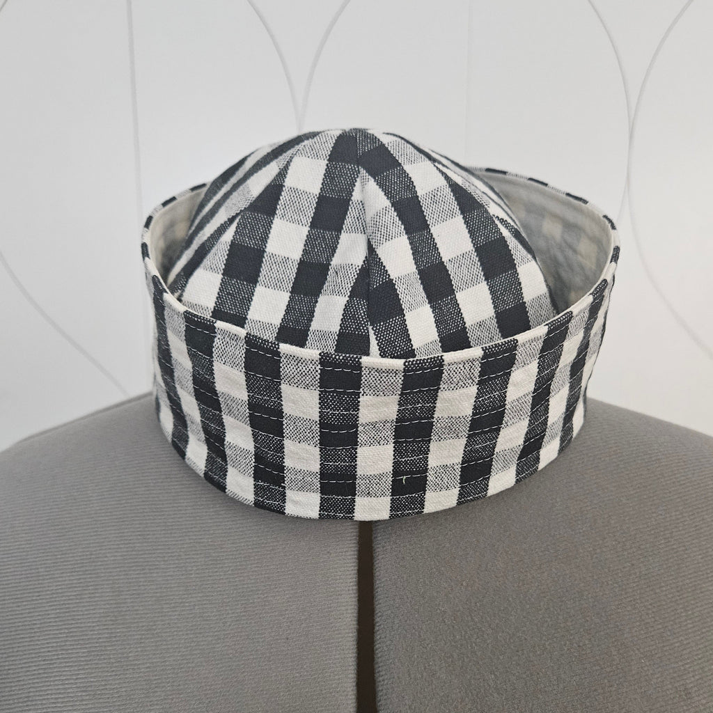 Front of black and white gingham sailor hat on a dress form