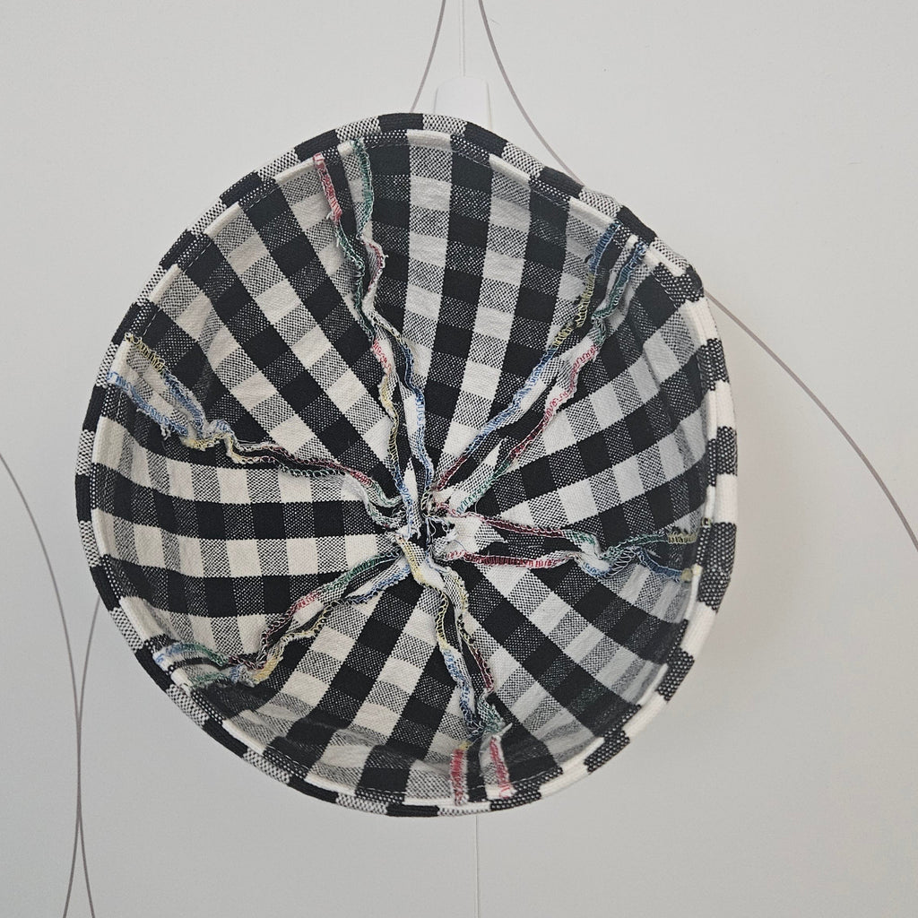 Inside serged seams of black and white gingham sailor hat