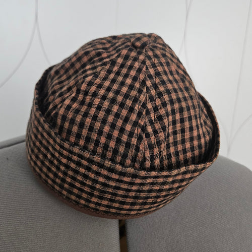 Front view of brown and black brimless cap