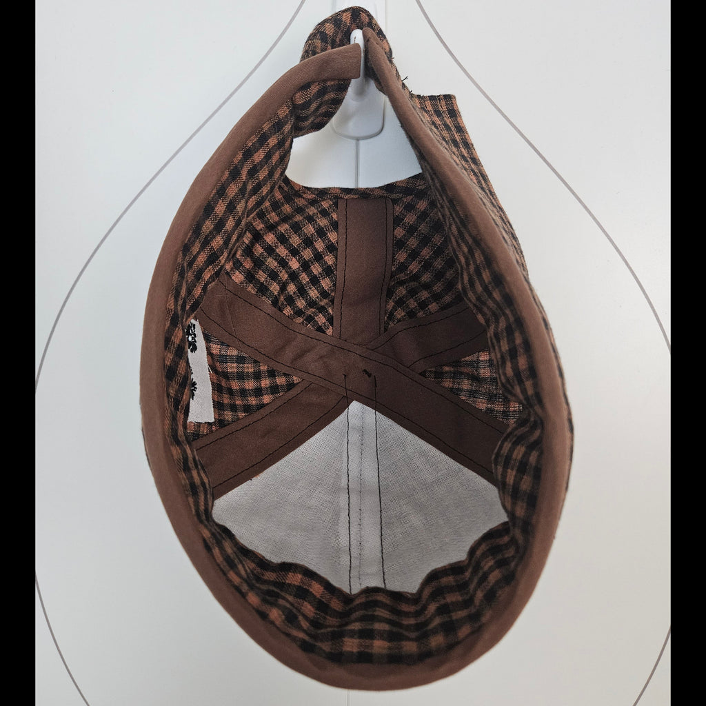 Inside view of brown and black gingham brimless cap