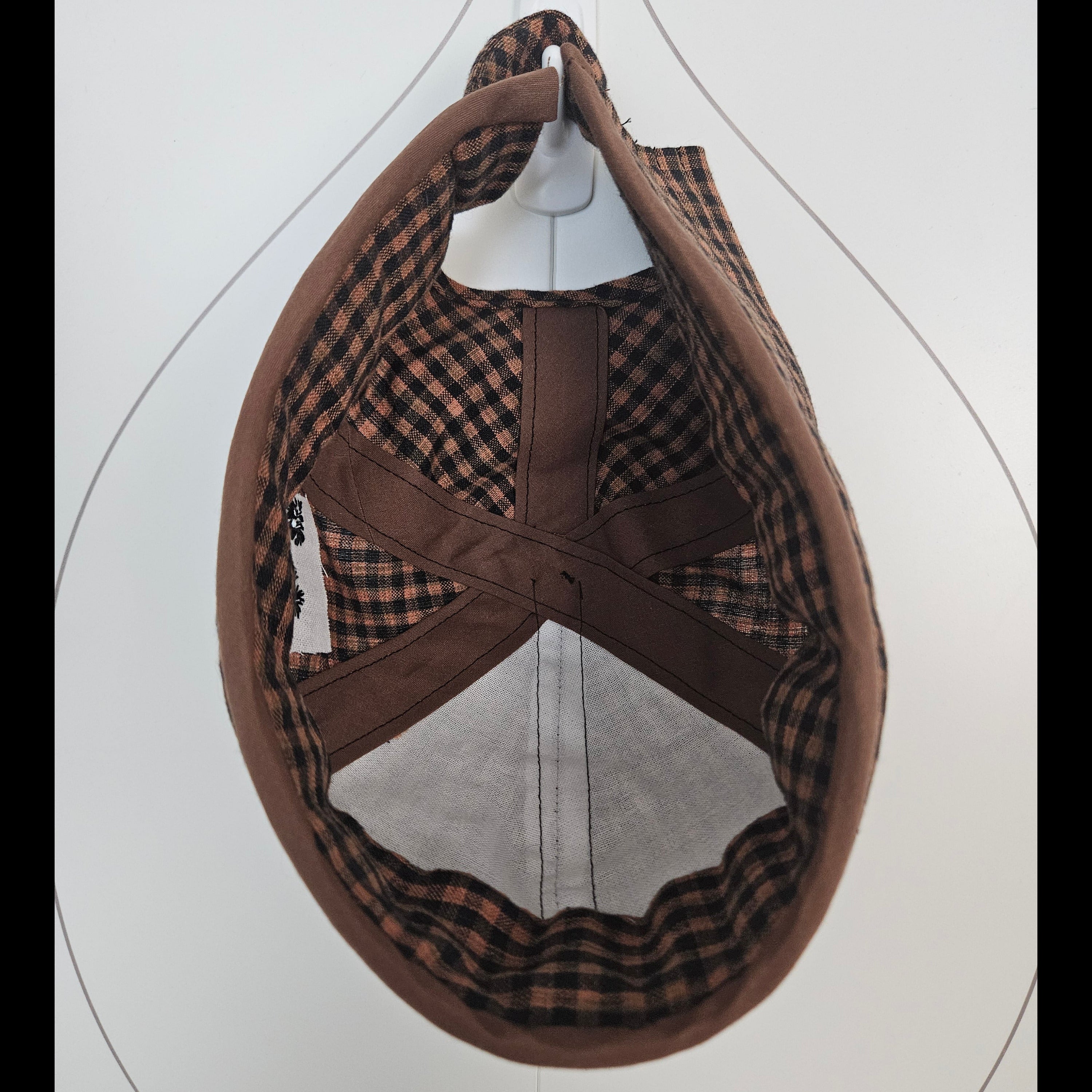 Inside view of brown and black gingham brimless cap