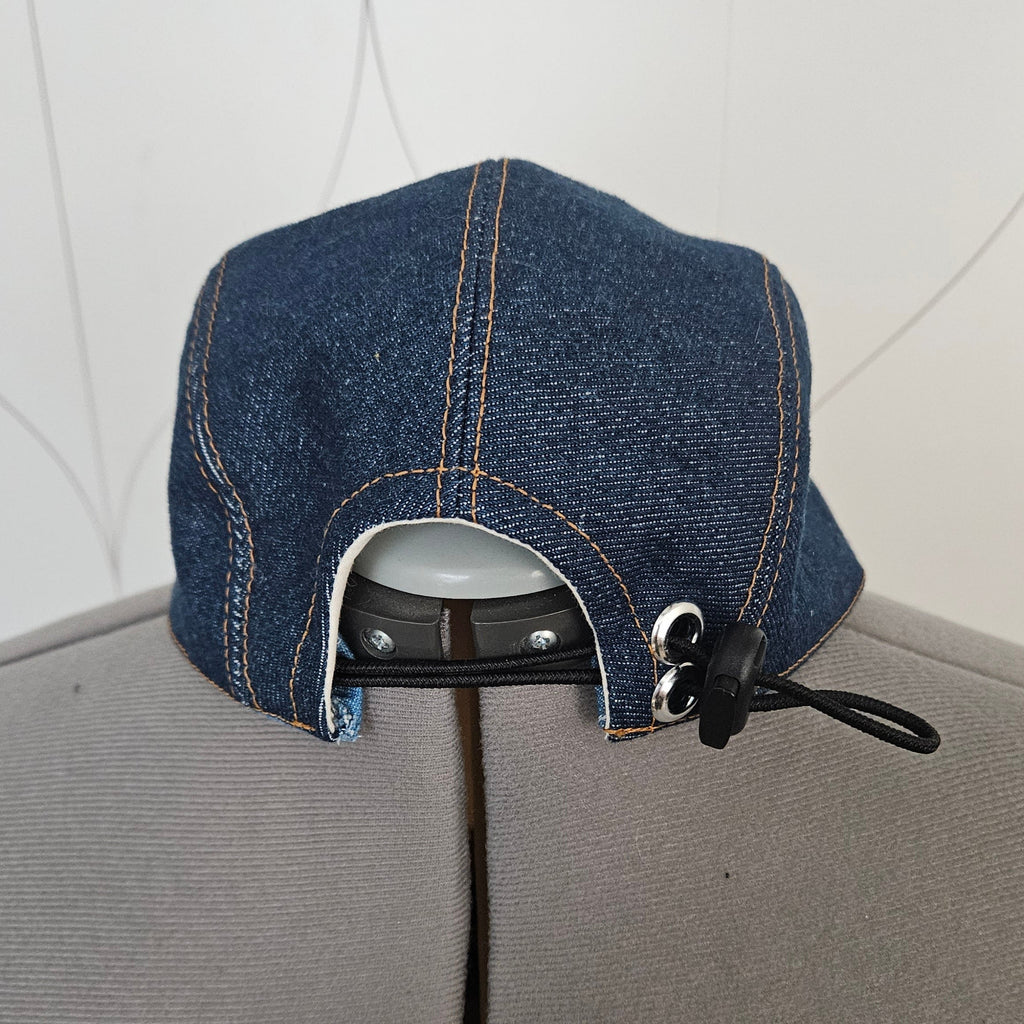 Back view of a denim camp hat