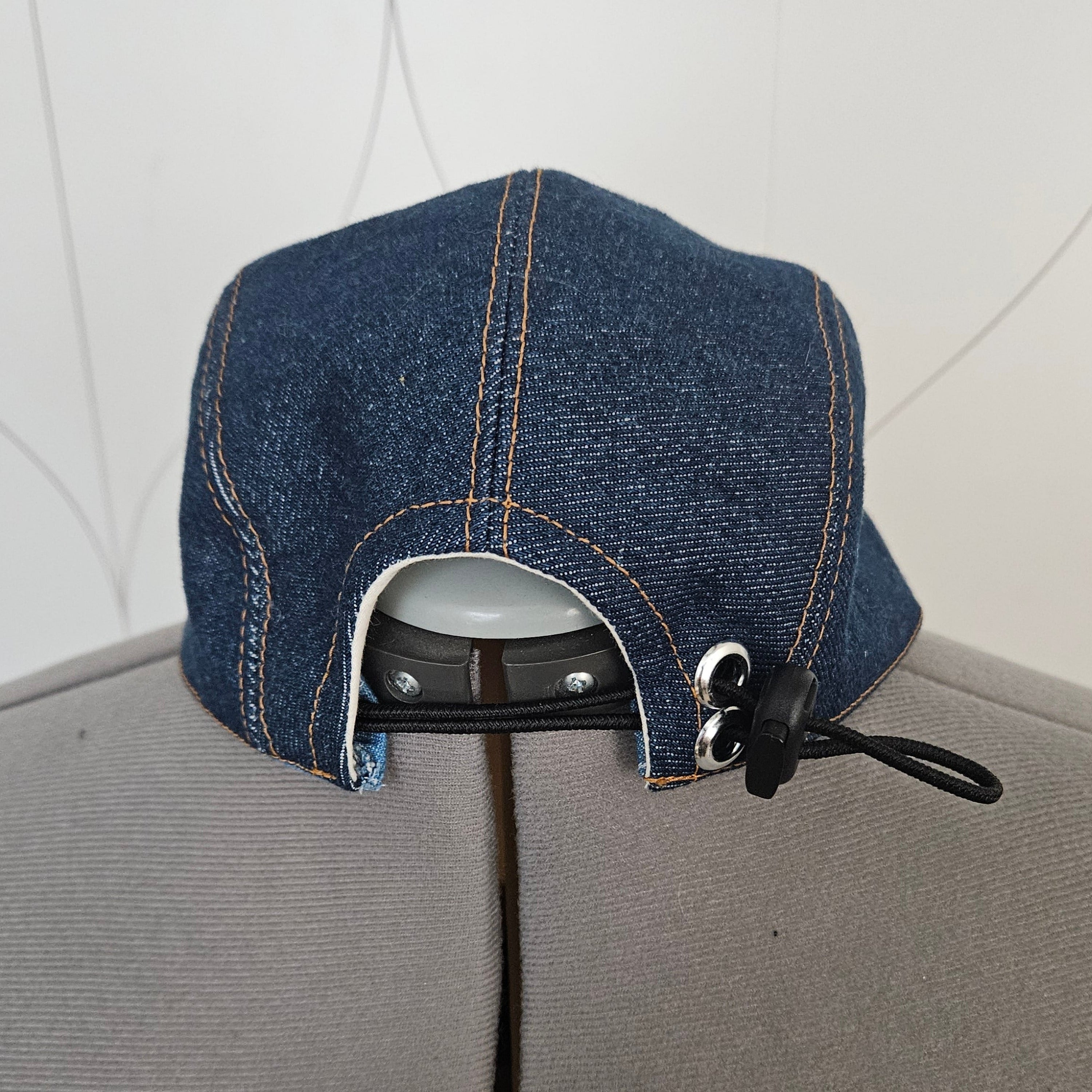 Back view of a denim camp hat