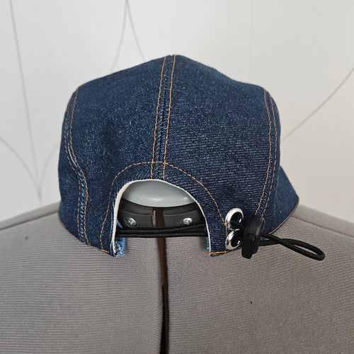 Back view of a denim camp hat