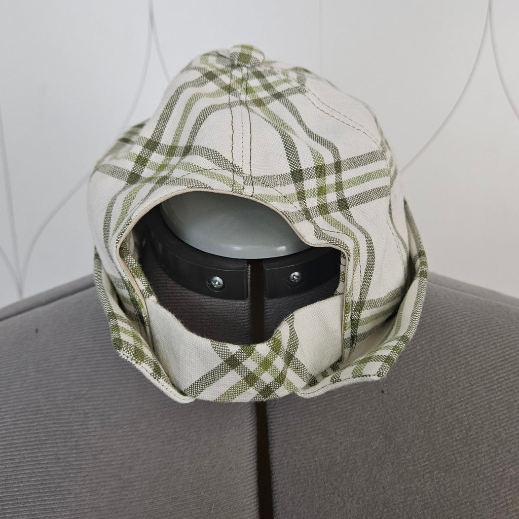 Back view of green and white brimless cap