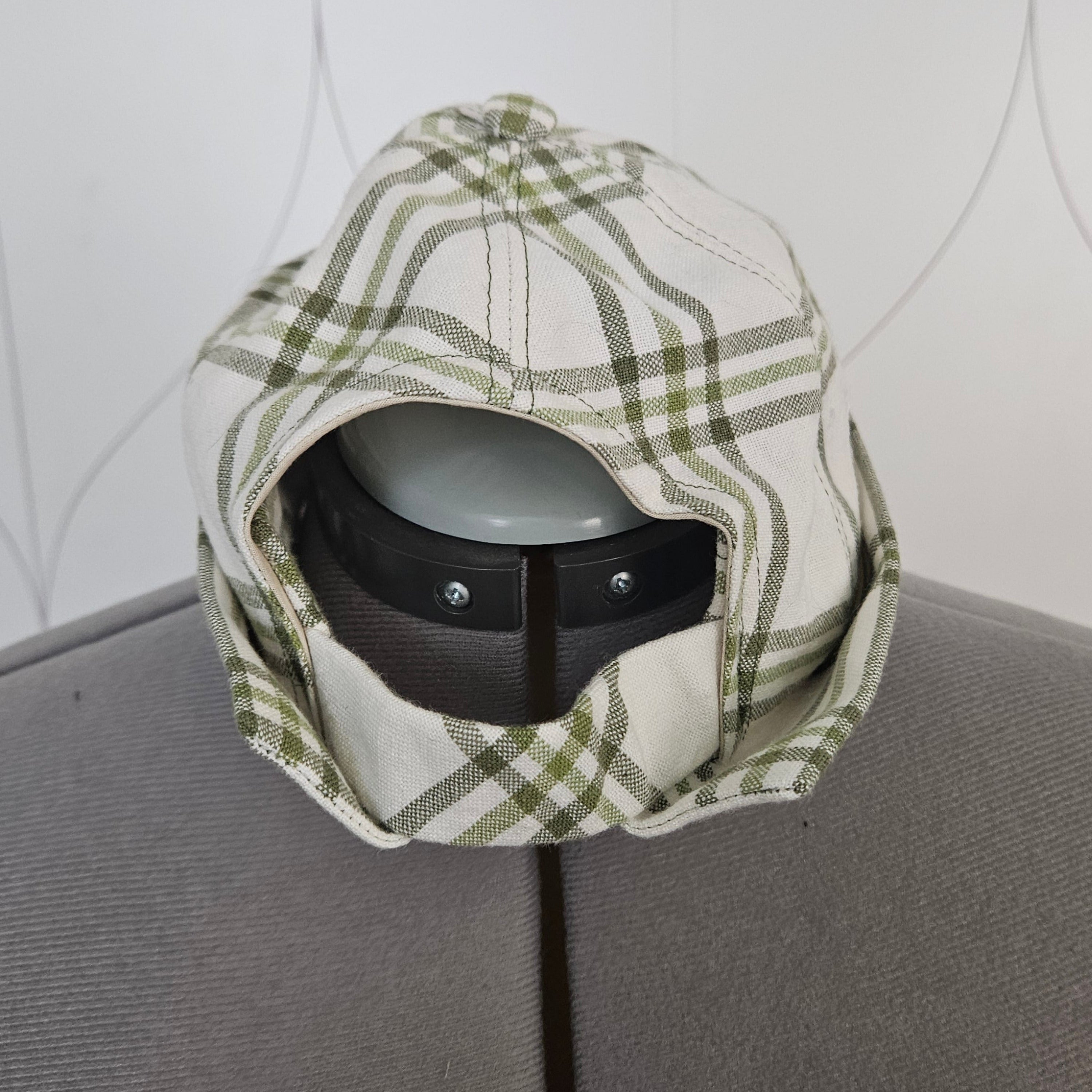 Back view of green and white brimless cap