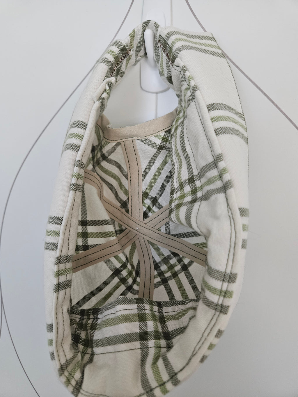 Inside view of green and white plaid brimless cap