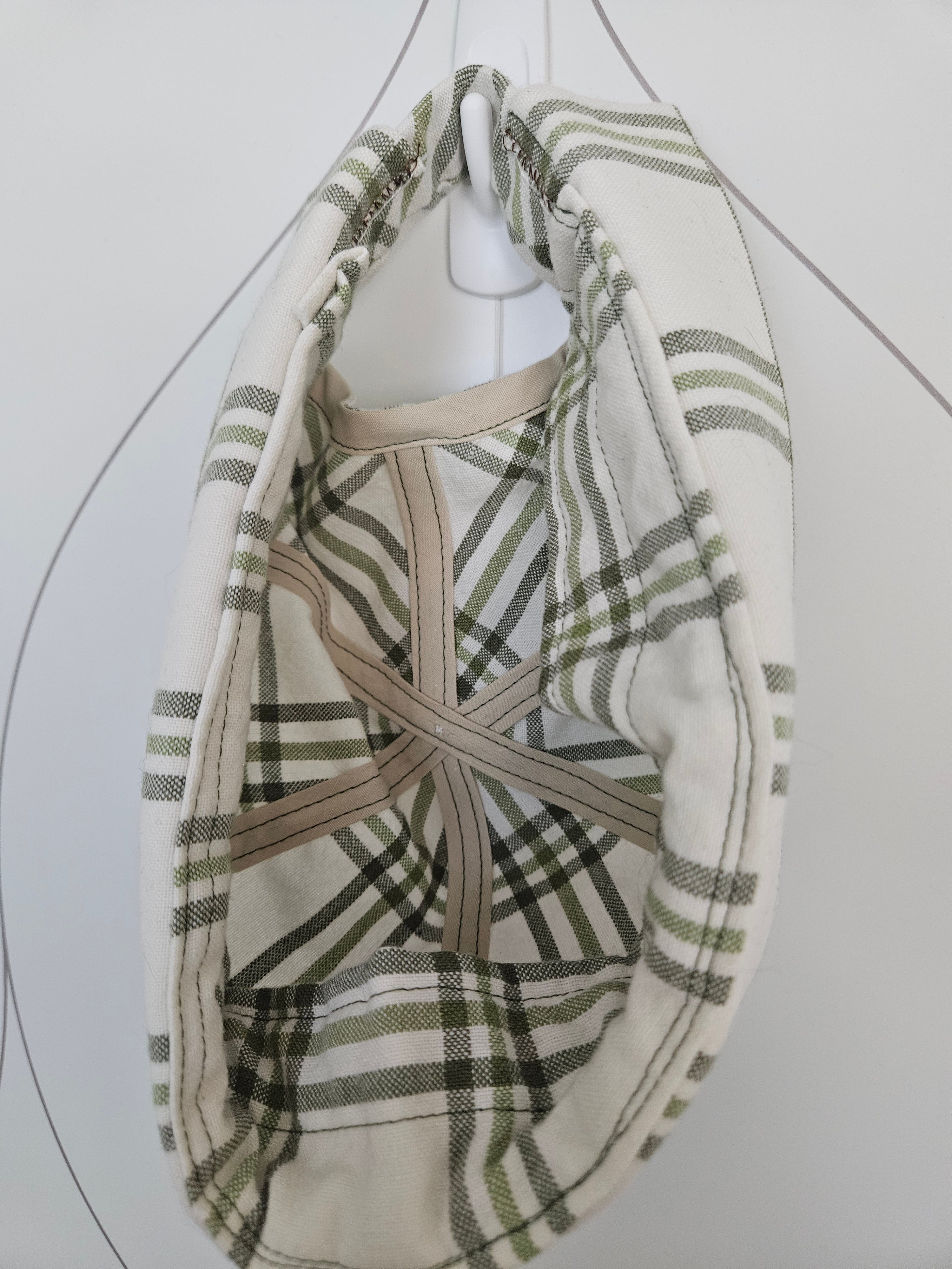 Inside view of green and white plaid brimless cap