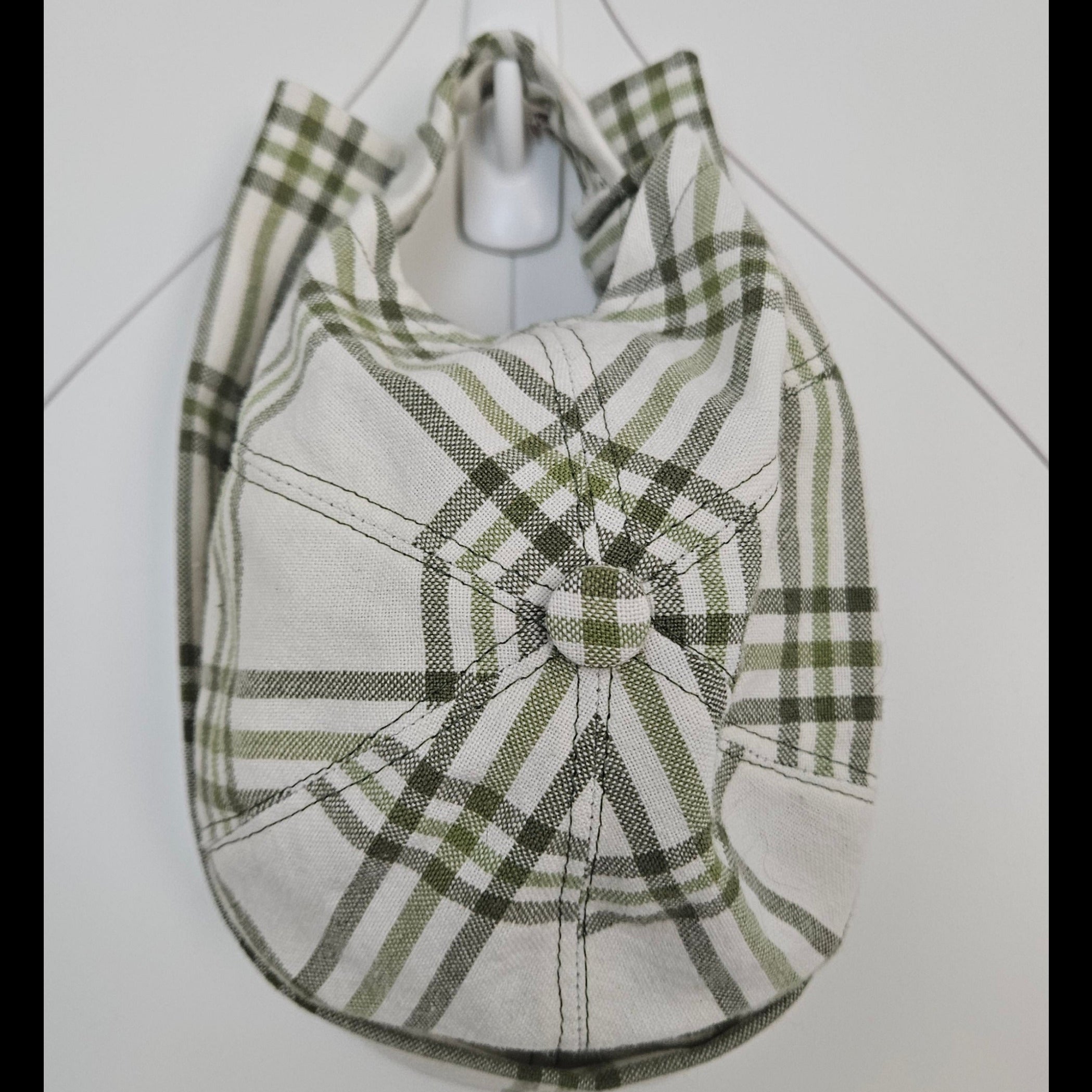 Top view of green and white plaid brimless cap