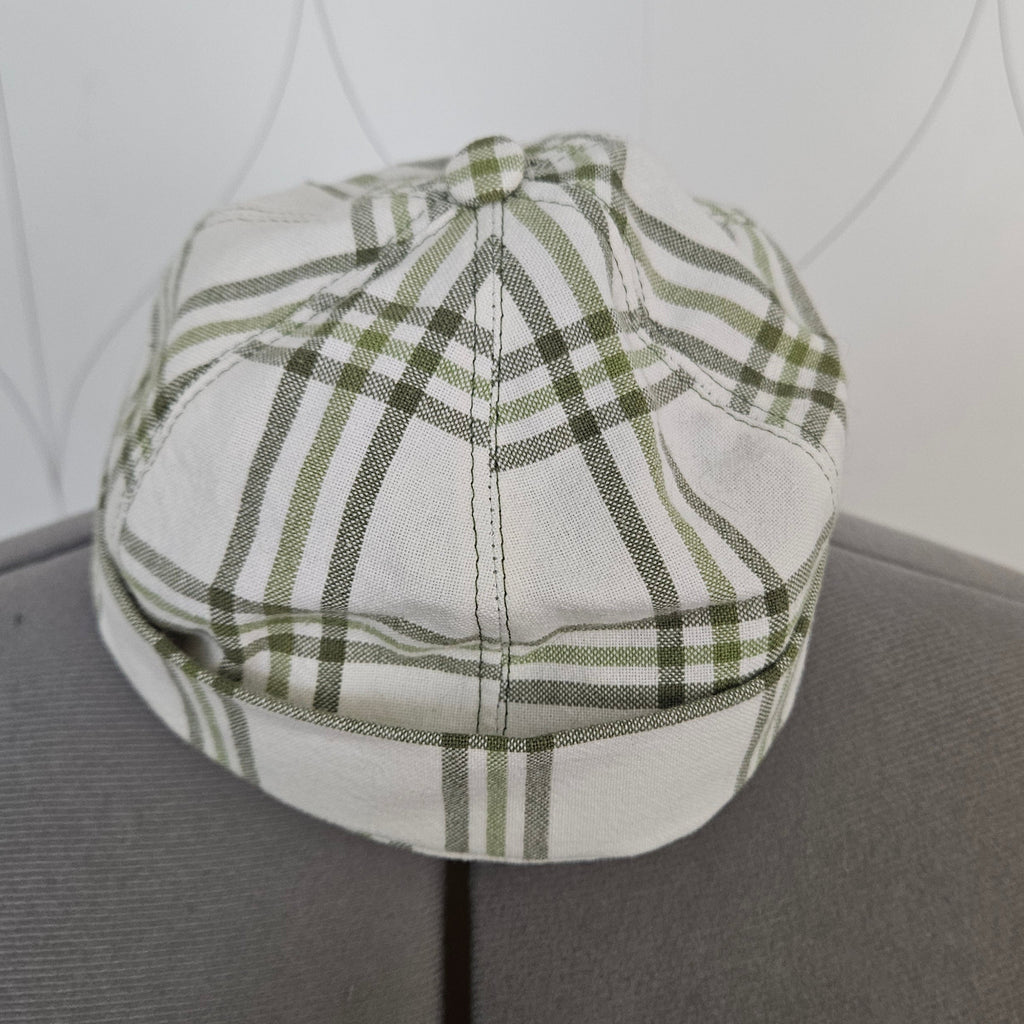 Front view of green and white plaid brimless cap