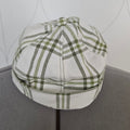 Front view of green and white plaid brimless cap