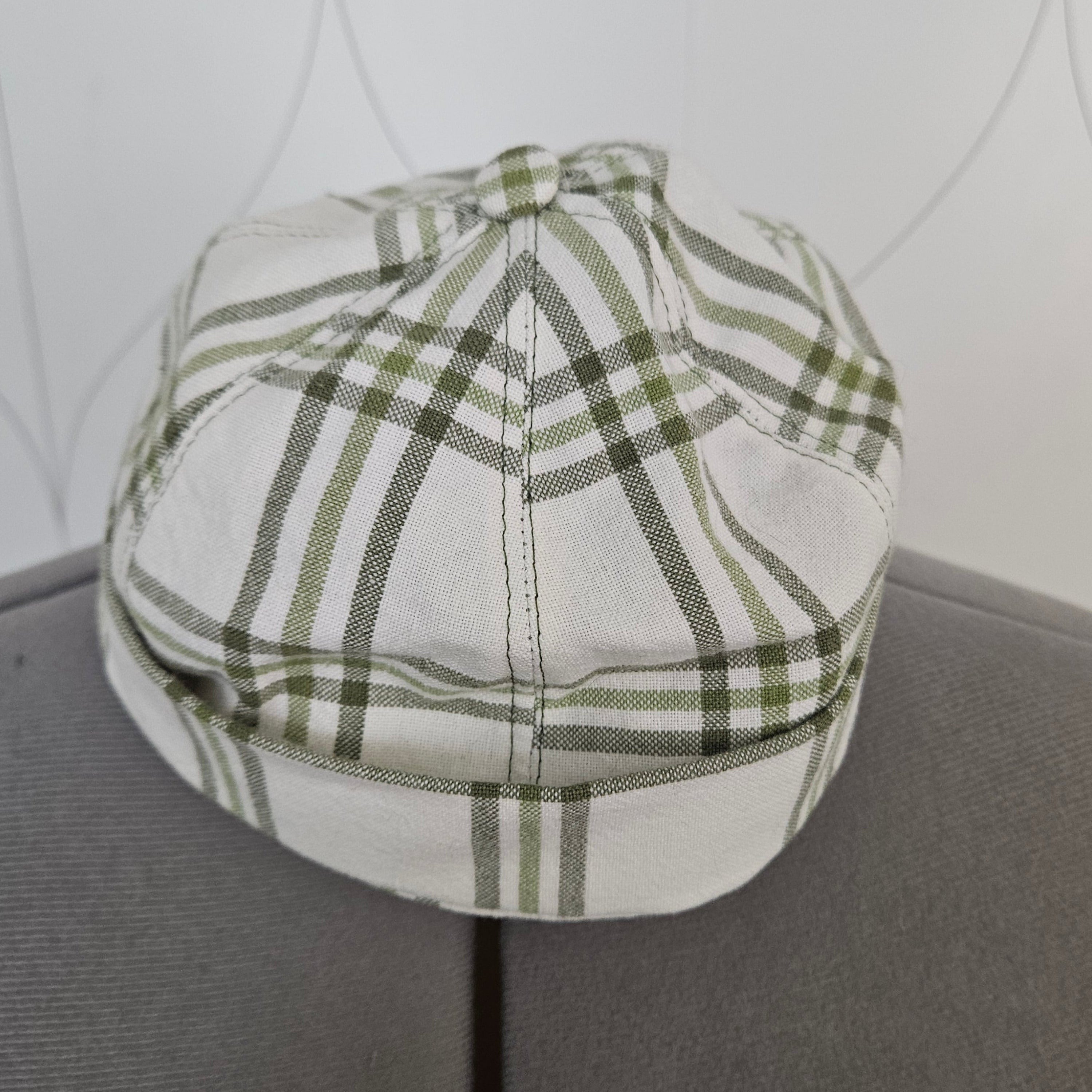 Front view of green and white plaid brimless cap
