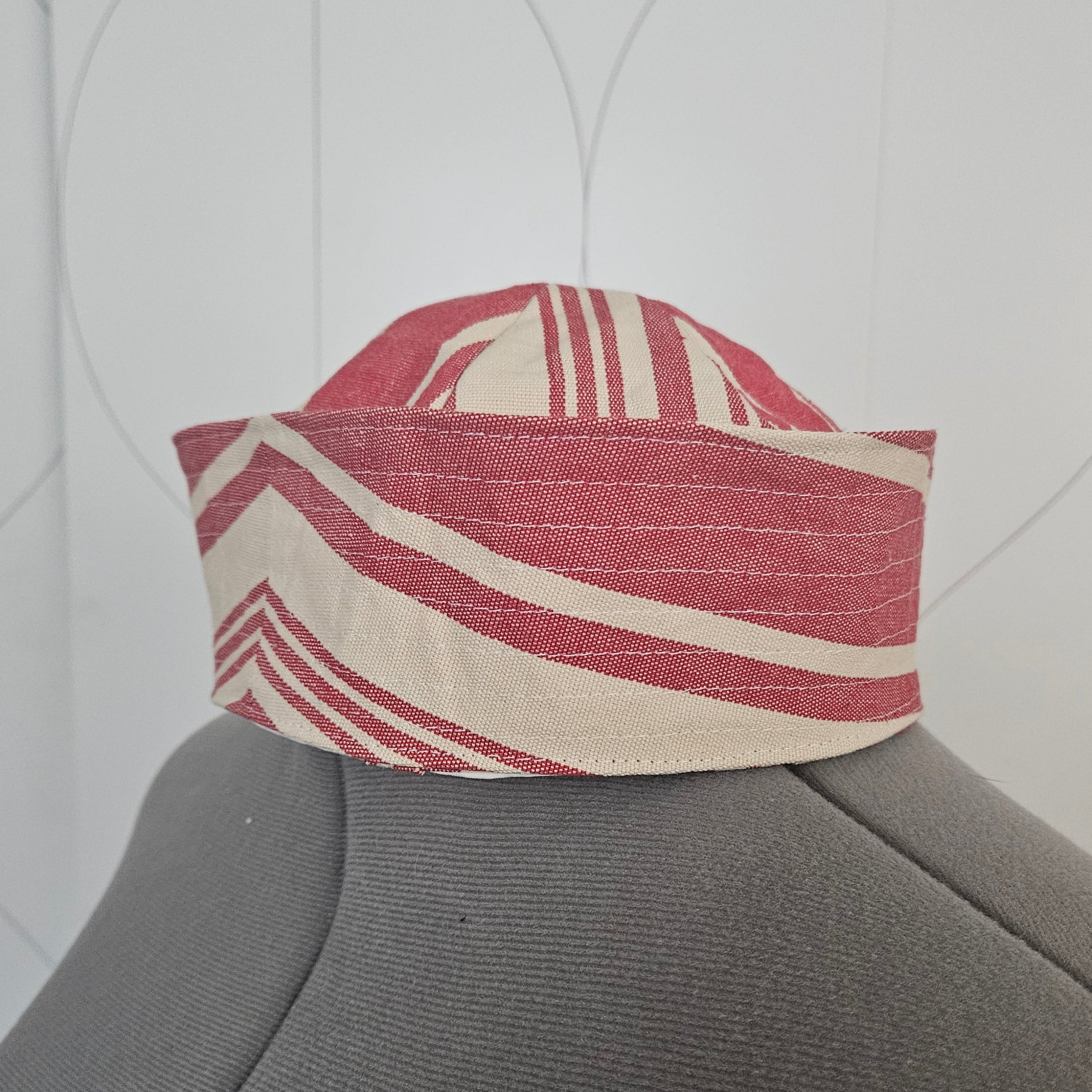 Side of red and white striped sailor hat on a dress form