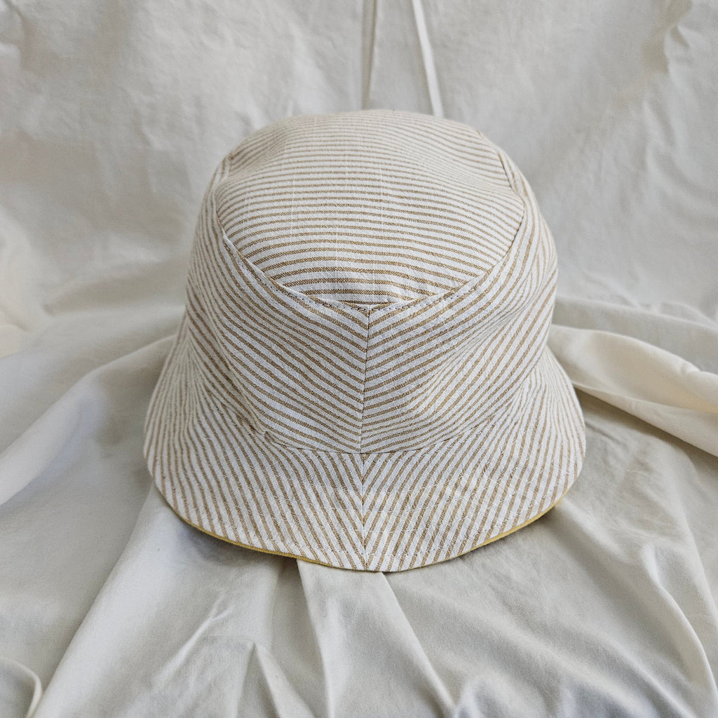 Striped bucket hat on a white fabric background