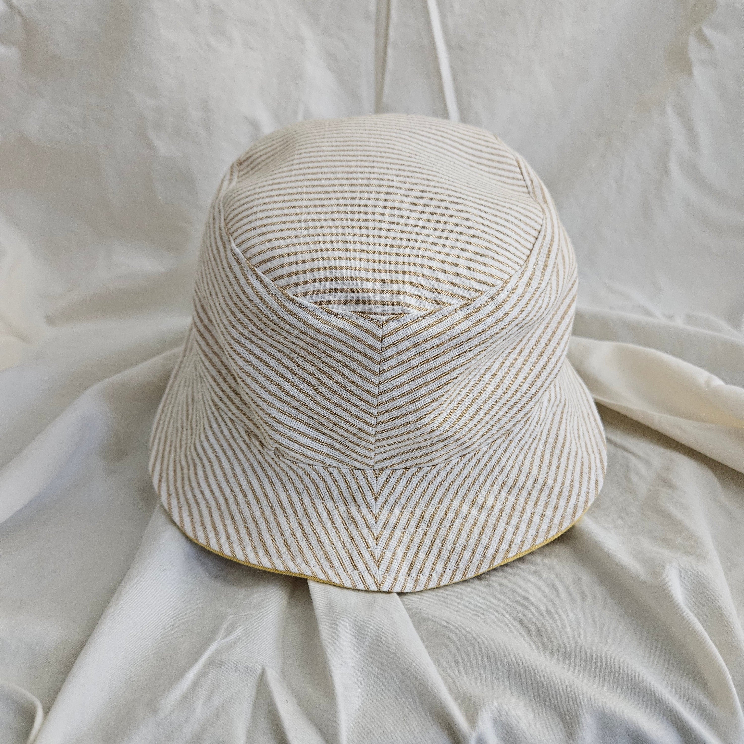 Striped bucket hat on a white fabric background
