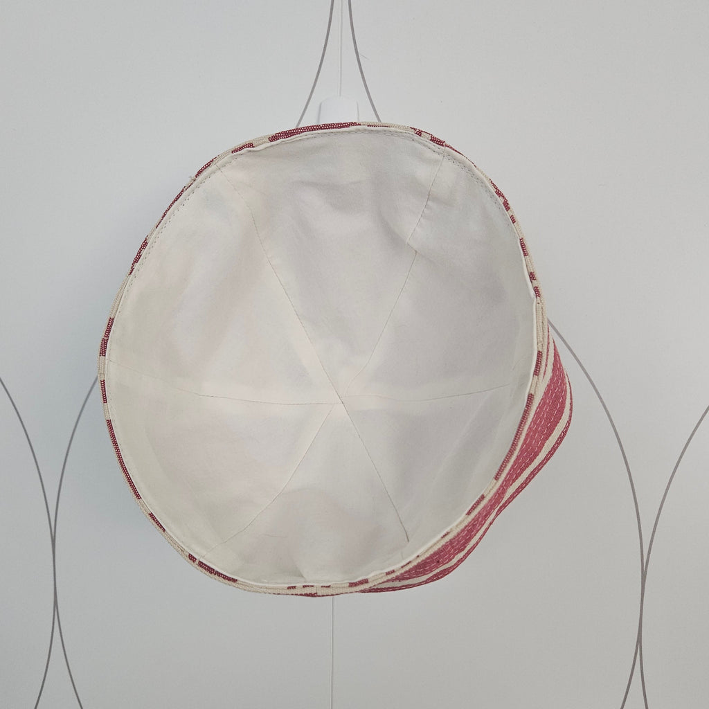 Inside white lining of red and white striped sailor hat