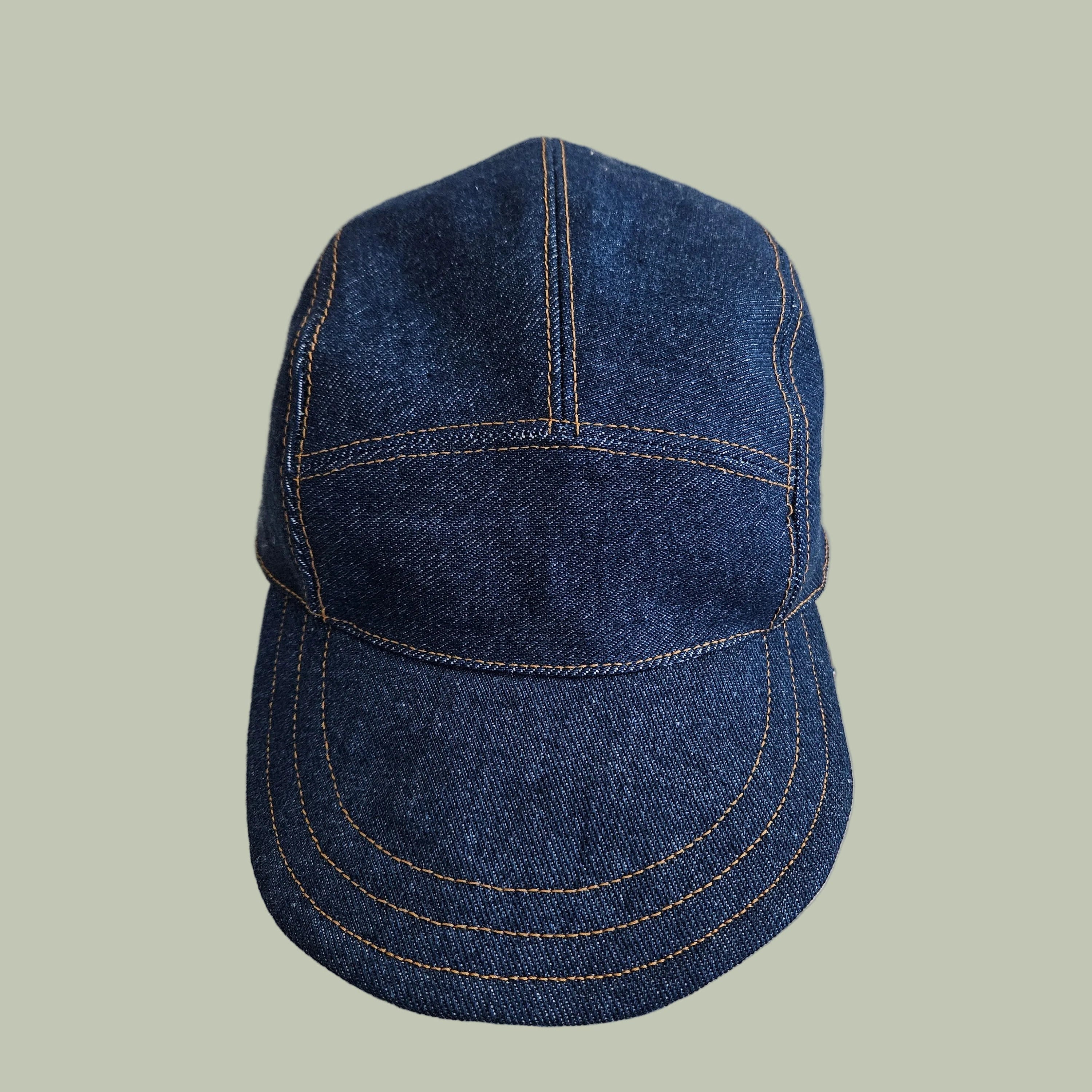 Blue denim cap on a white fabric background